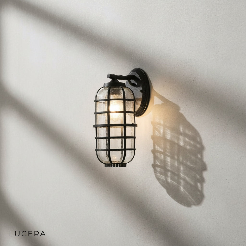 Elara outdoor sconce in vintage black finish against a brick exterior wall