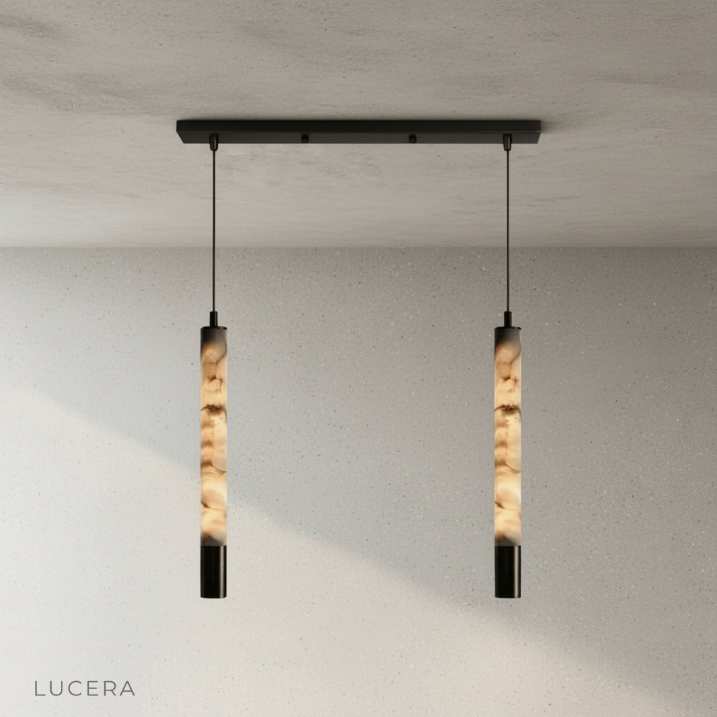 Yseult pendant light over a bedside table in a calm bedroom with cream curtains and soft shadows
