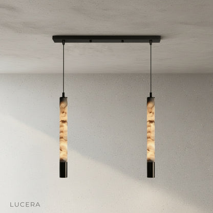 Yseult pendant light over a bedside table in a calm bedroom with cream curtains and soft shadows