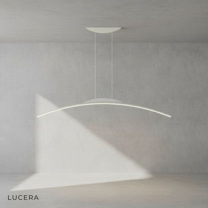 Minimalist black chandelier above a round table in a sunlit breakfast area