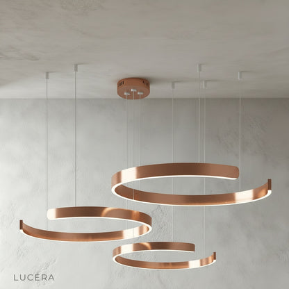 Bedeck chandelier at low height above glass table in sunlit conservatory