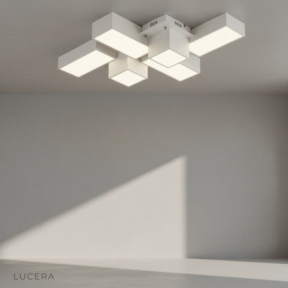 Black rectangular ceiling light illuminating dark accent wall in lounge