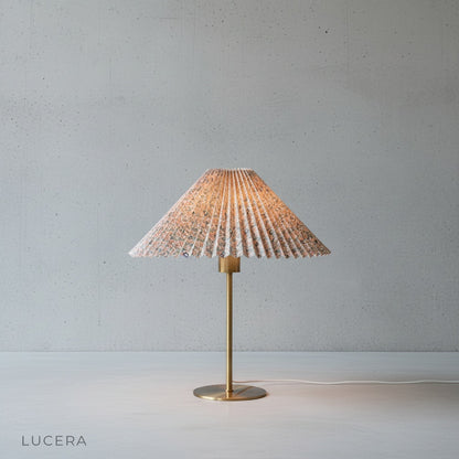 Ysabel Table Lamp casting a warm glow on a bedside table in a dark, cozy bedroom at night