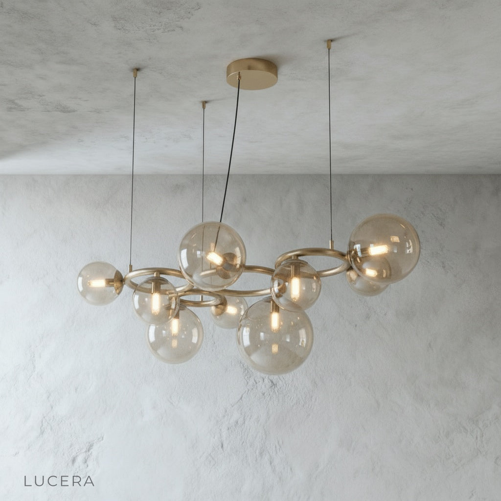 Grenache chandelier with warm glow against dark wall in lounge