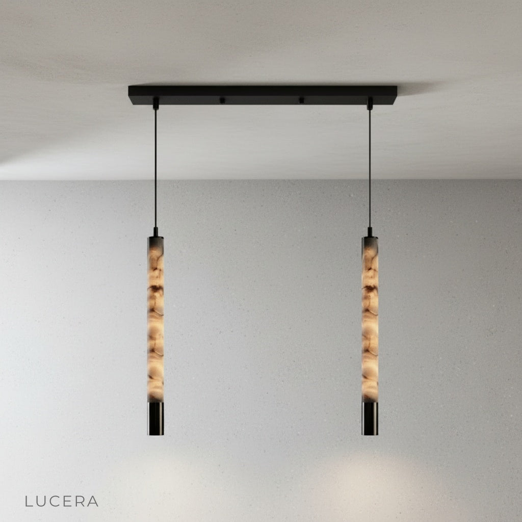Yseult pendant light in a modern entryway with high ceiling and polished concrete wall texture