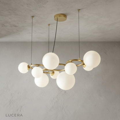 Grenache chandelier in minimalist dining area with wooden table
