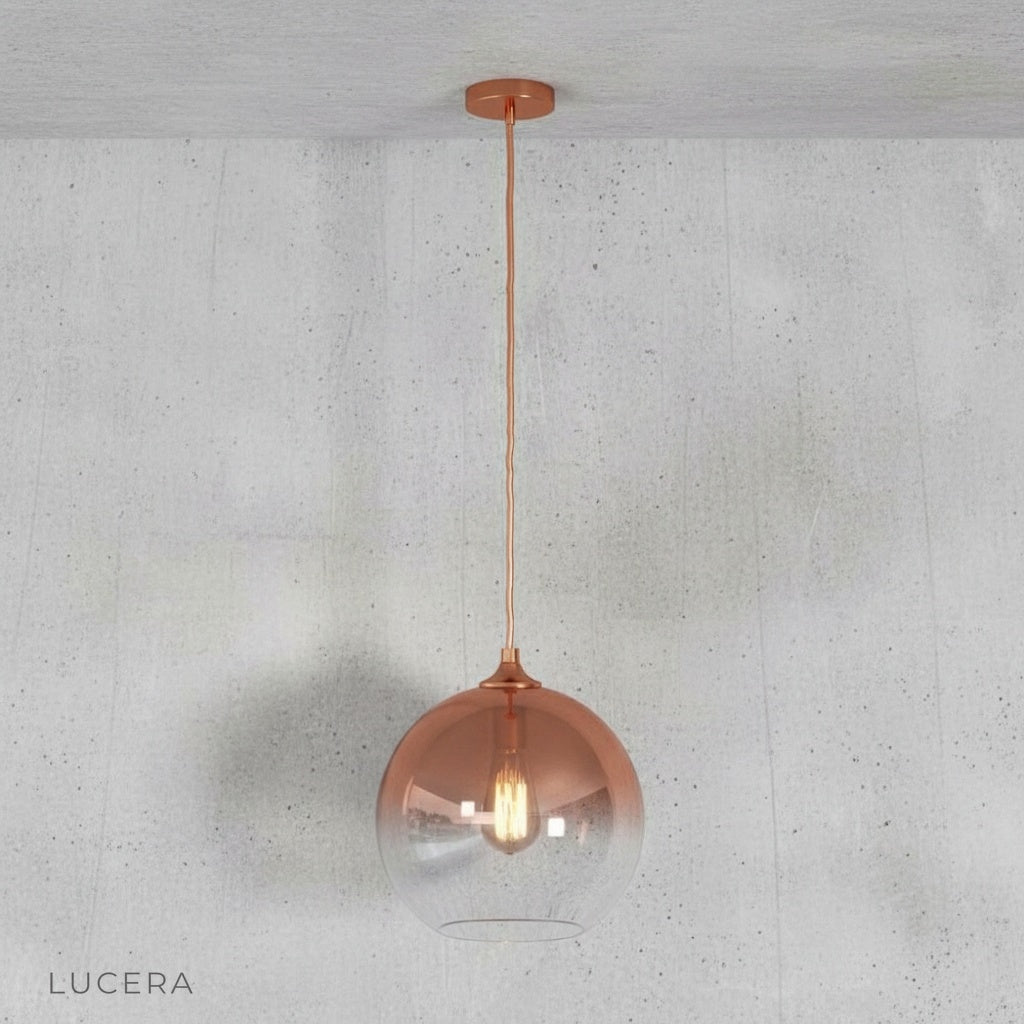 Green gold pendant light in an open-plan space with neutral tones and natural light