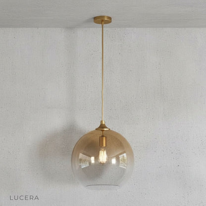 Nighttime shot of green gold pendant light creating intimate ambiance in a reading nook