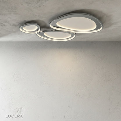 Tantalus ceiling light nighttime shot with elegant shadows and bright diffuser