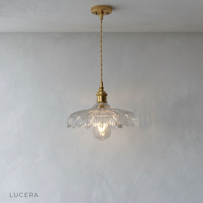 evening lifestyle shot of pendant light illuminating breakfast bar in open concept kitchen