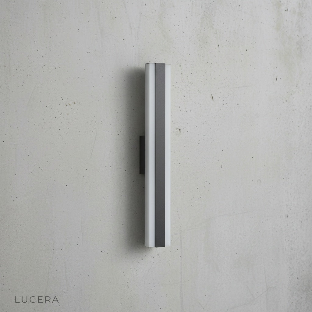 sleek Drambuie fixture mounted on white stucco wall with soft shadow play at sunset