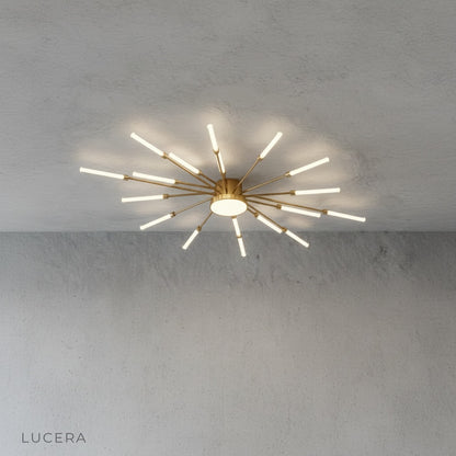 Karma chandelier in minimalist entryway with soft glow reflecting off polished concrete floor