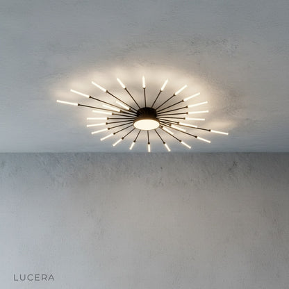 close-up of Karma chandelier warm LED filaments and matte black finish in dark room