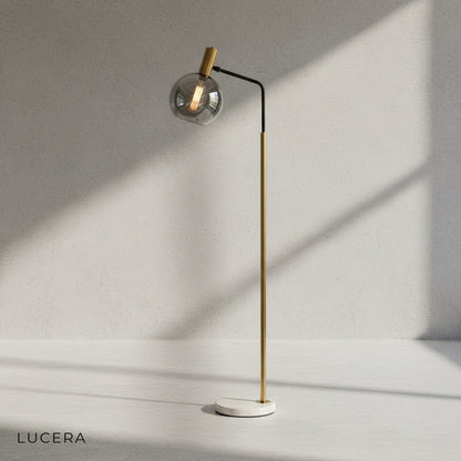 Gold metal arm detail with warm light diffusing through glass