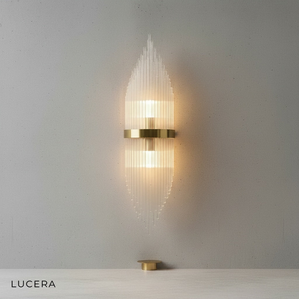 Detail view of Lento sconce switch and gold finish on stainless steel arm