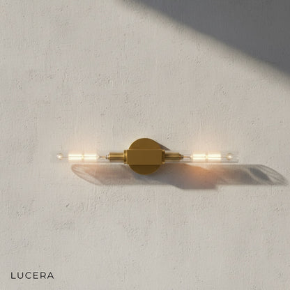 Ravello black wall sconce mounted in bathroom near mirror with warm light