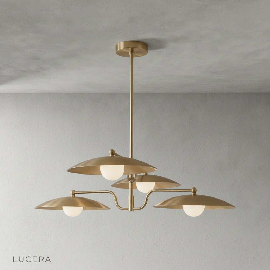 Close-up detail of smooth brass finish and gently curved arm on Stellar Chandelier