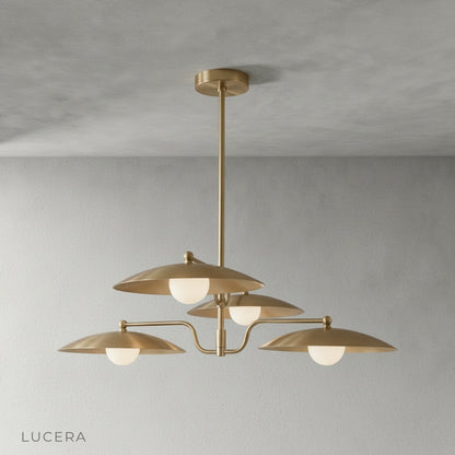 Close-up detail of smooth brass finish and gently curved arm on Stellar Chandelier