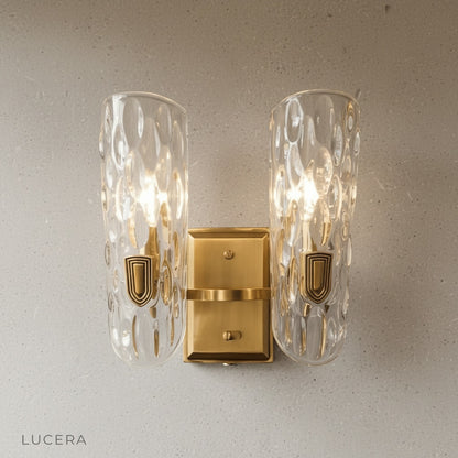 Close-up of Jubilant Wall Lamp polished copper arm and glass shade detail