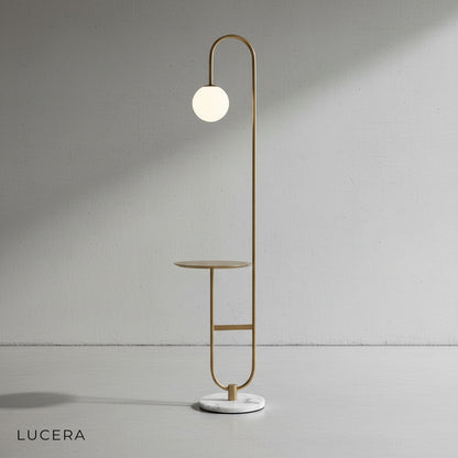 Art Deco LED floor lamp with table in a cozy reading corner with a book and coffee mug on the shelf