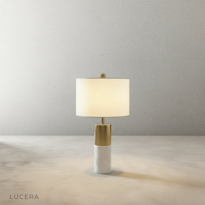 Close-up detail of Essere Table Lamp marble base and sleek metal stem against neutral backdrop
