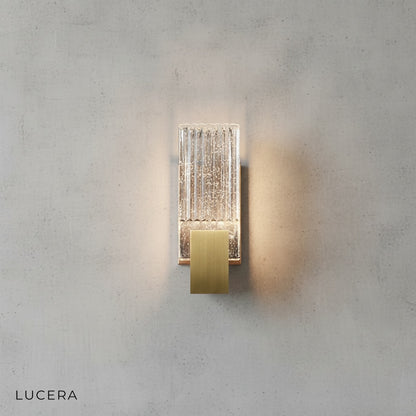 Slargando crystal sconce with warm glow in cozy reading nook beside armchair