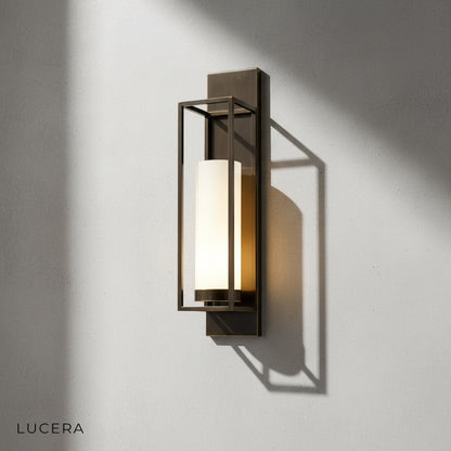 Pair of gold palace wall lamps flanking a mirror in modern hallway decor