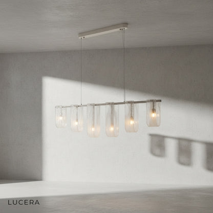 Angle view of Fuchsia Liora glass pendant light with warm light glowing through fuchsia shades
