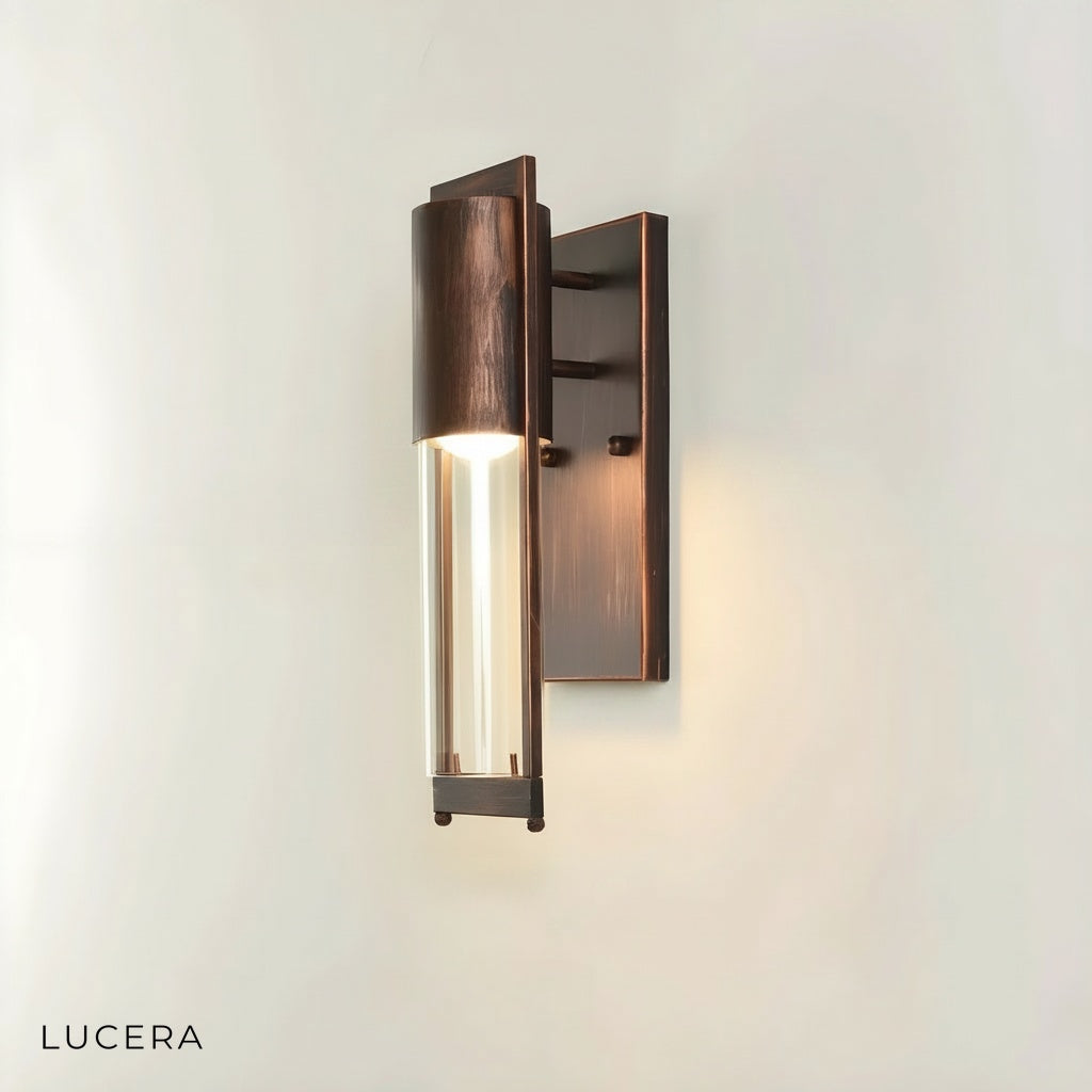 Viviane wall light mounted on a brick exterior wall with warm ambient light at dusk