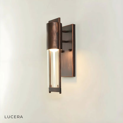 Viviane wall light mounted on a brick exterior wall with warm ambient light at dusk