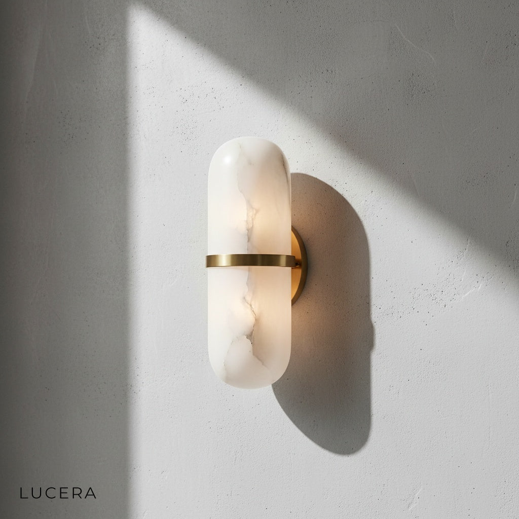 copper and marble wall sconce illuminating hallway entrance