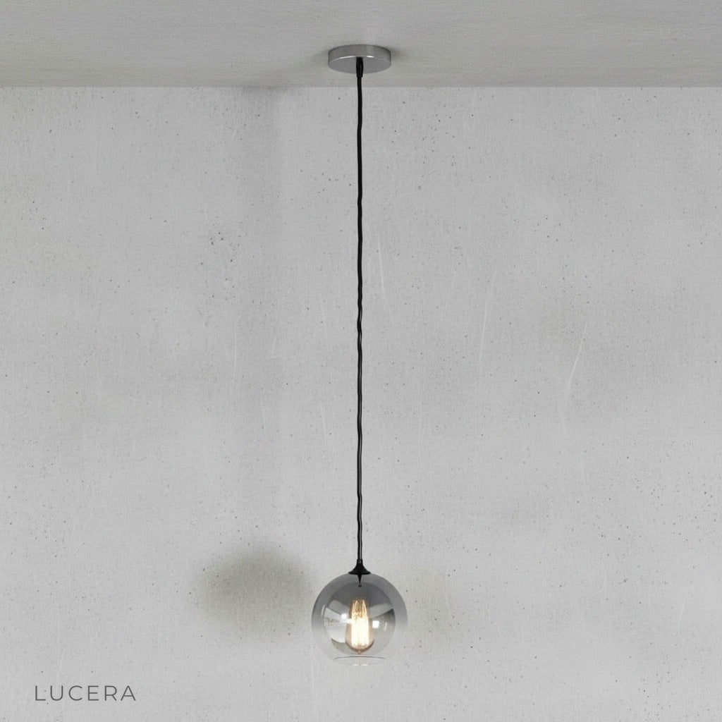 Front view of Lucera green gold ombre glass pendant light in minimalist studio setting