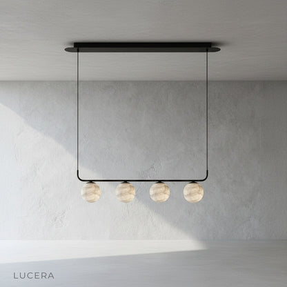 Close-up of Bibelot pendant lamp warm LED light through alabaster diffuser