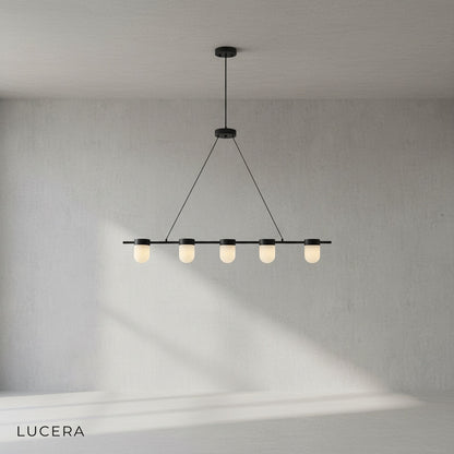 Black and copper Art Deco chandelier hanging above dining table with soft glow
