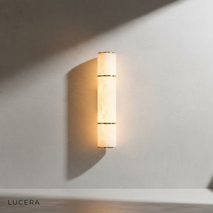 Vague marble wall lamp in medium size mounted above a bedroom nightstand with soft ambient light