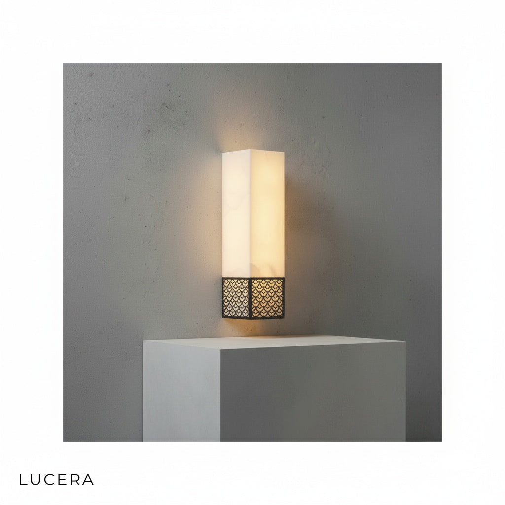 Vertical Astragal marble wall lamp illuminating dark textured wall with soft 3000K glow