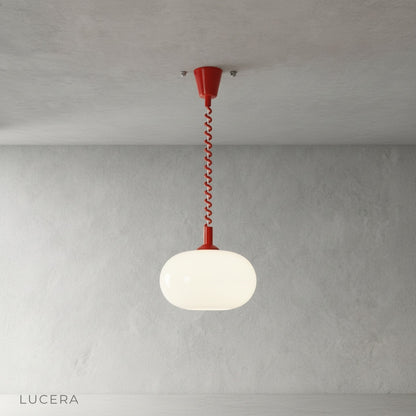 Close-up of Xanthous pendant light opal glass shade and cable adjustment mechanism