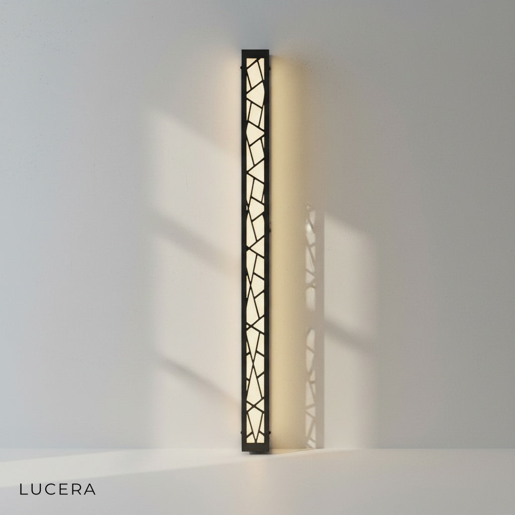 Giselle LED Lamp with cool white glow against dark brick wall texture