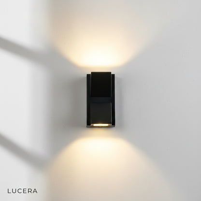 Pair of Cora LED sconces flanking a contemporary garage entrance, neutral light