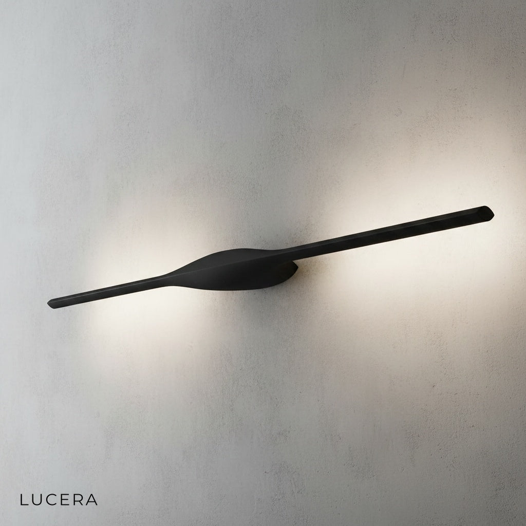 Elan wall lamp in brushed aluminum finish mounted on neutral wall in hallway