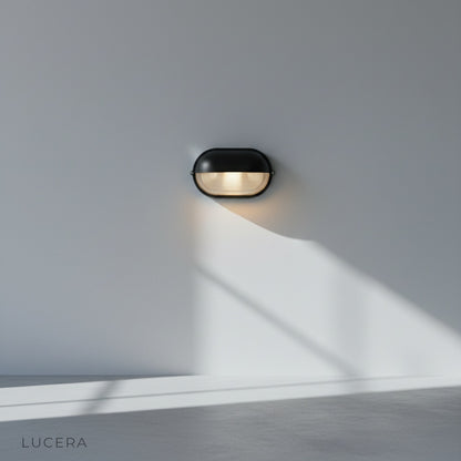 close-up of textured aluminum finish and clear glass panel on Acolyte lamp