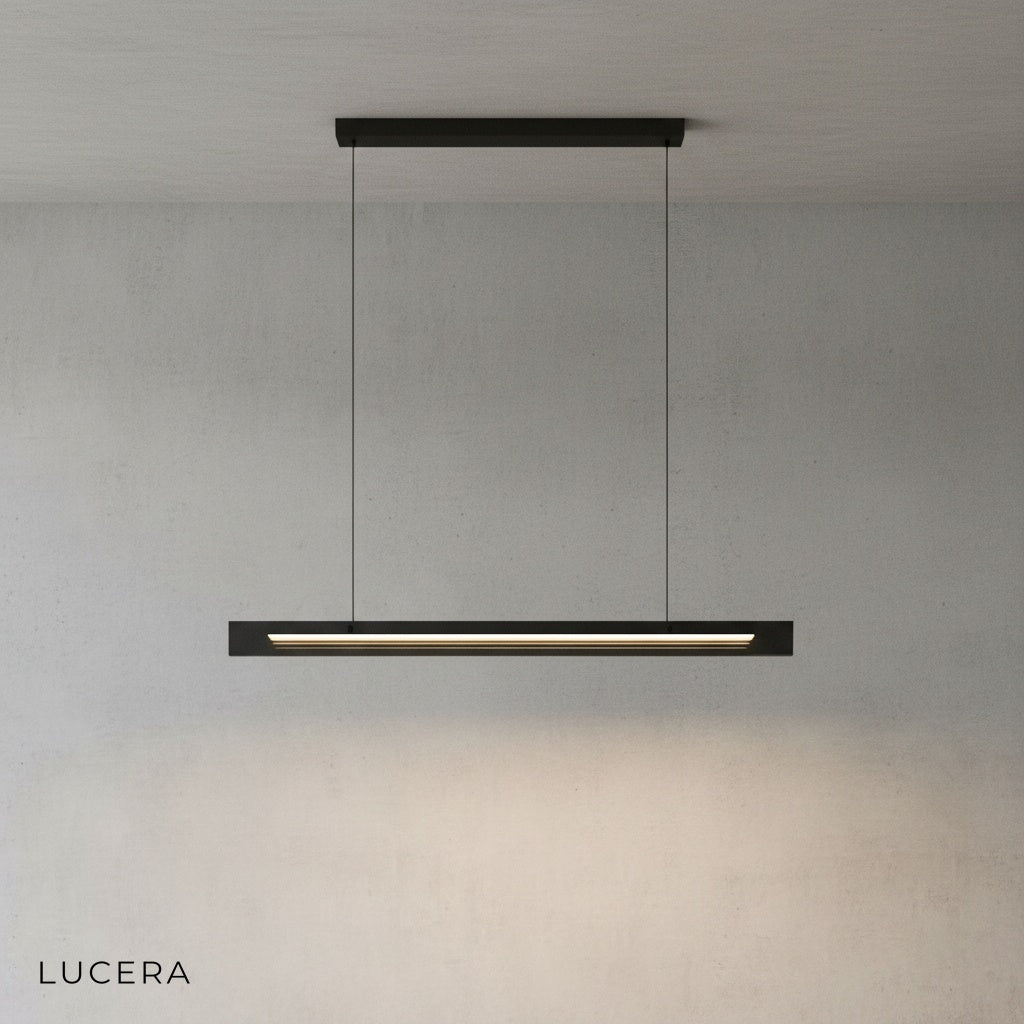 linear black chandelier illuminating kitchen island with warm ambient light