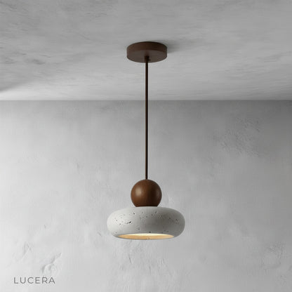 Minimalist studio view of Mensa Pendant Light showing sculptural stone texture