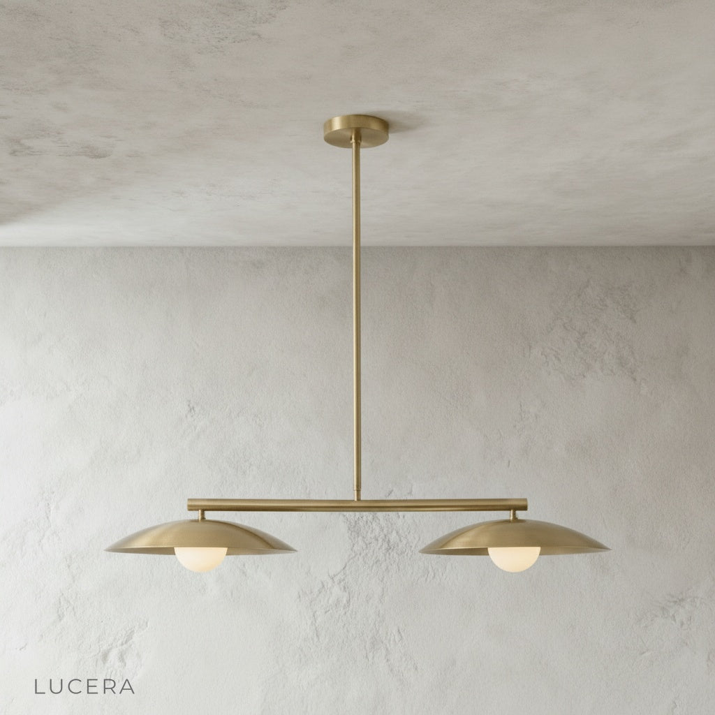 Close-up detail of the smooth metal disc shades and spherical bulb connection on the Lucera pendant