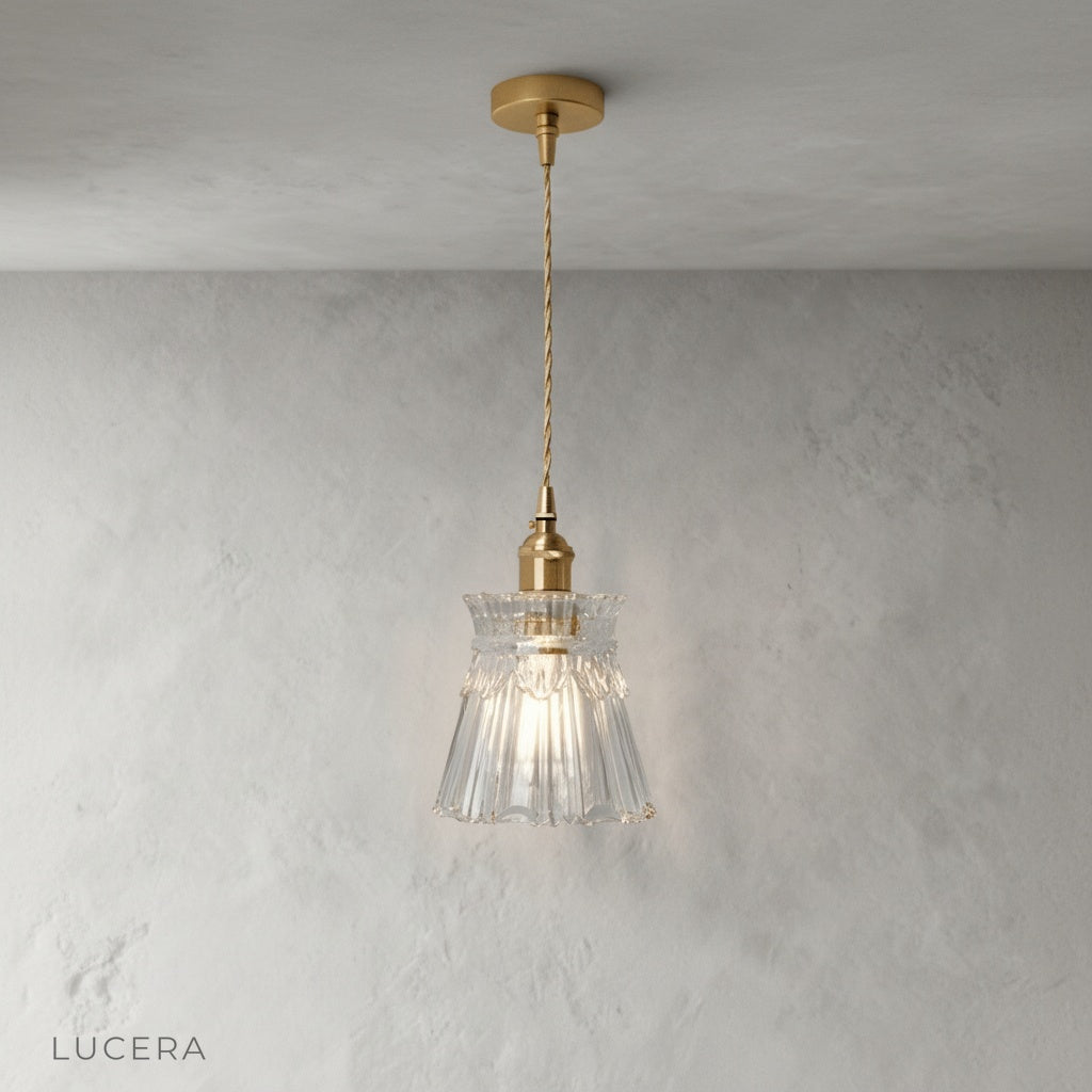 close-up detail of brushed brass pendant light glass diffuser with warm glow