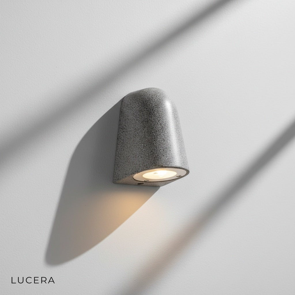 Close-up detail of handcrafted microcement texture on Eos Architectural Outdoor Wall Light