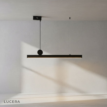 Angelo black chandelier hanging over a cozy living room sofa with soft warm glow