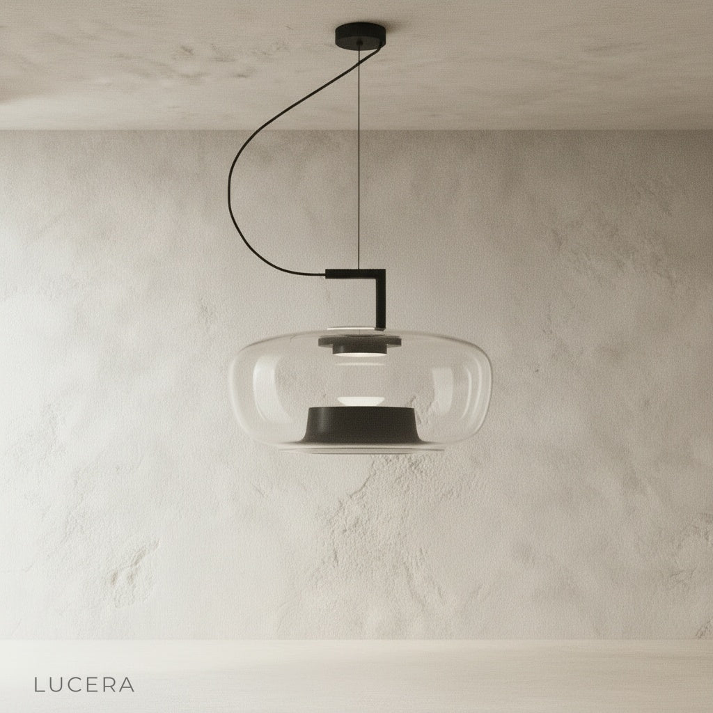 Yardang pendant light with amber glass shade casting warm glow in minimalist dining area