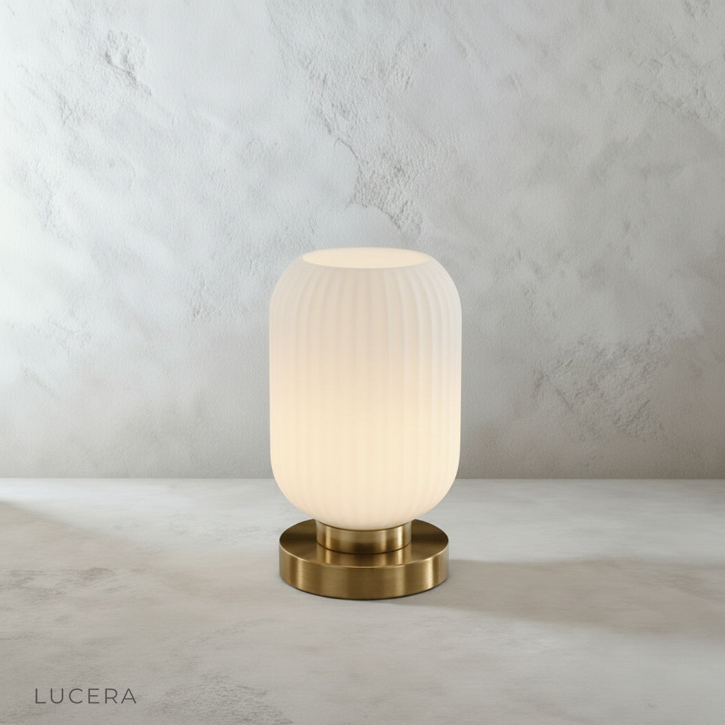 close up of ribbed glass shade refracting warm light into patterned shadows