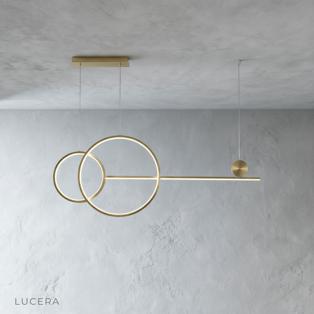Gold Brumal pendant light close-up showing acrylic and iron ring construction